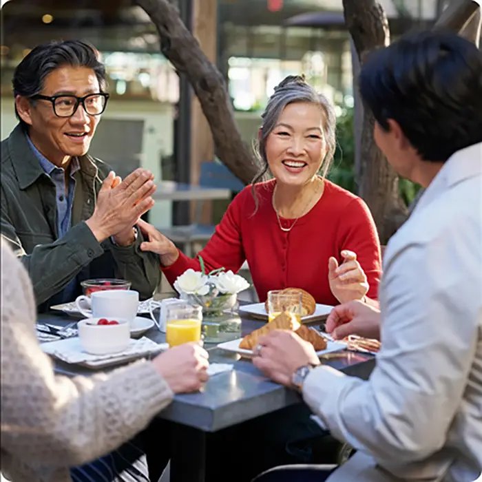 Group of adults dining at an outdoor restaurant