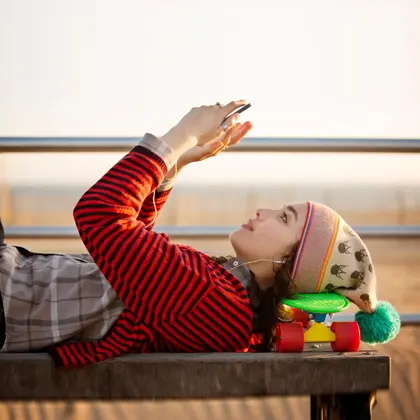 Student on bench with phone